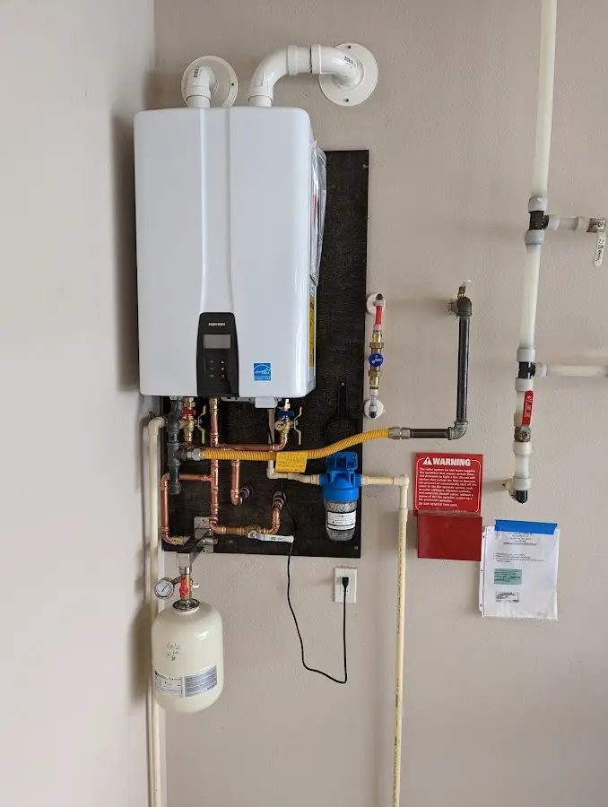 Professional plumber installing copper piping in a Mineral Springs home